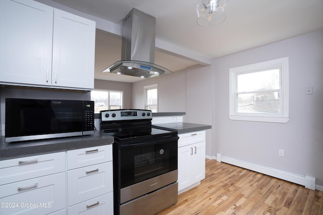 kitchen featuring island range hood, white cabinetry, appliances with stainless steel finishes, and a baseboard heating unit