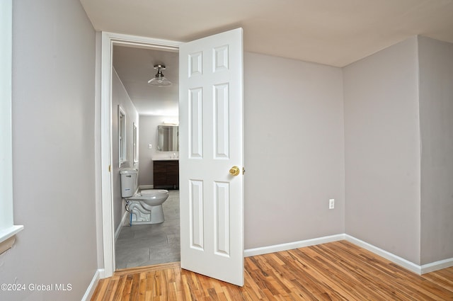 corridor with light hardwood / wood-style flooring