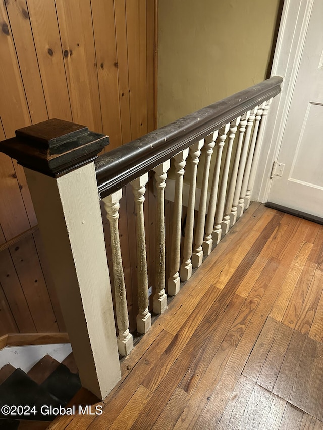 staircase with hardwood / wood-style flooring