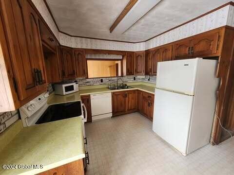 kitchen featuring white appliances and sink