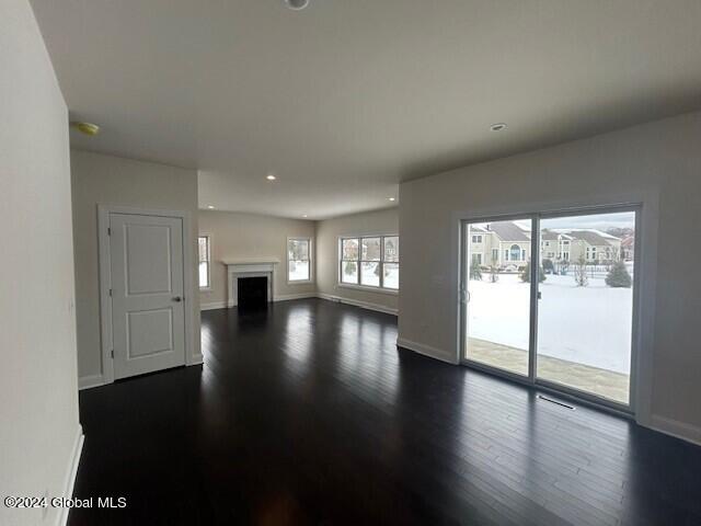 unfurnished living room with dark wood-type flooring