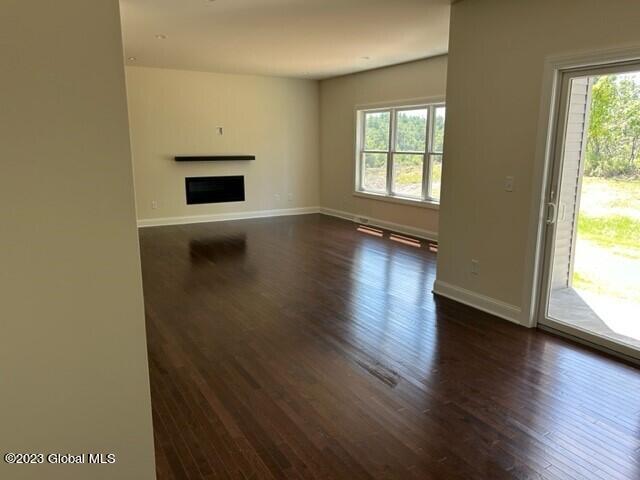 unfurnished living room featuring dark hardwood / wood-style flooring