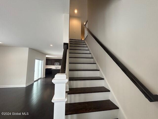 stairway with wood-type flooring