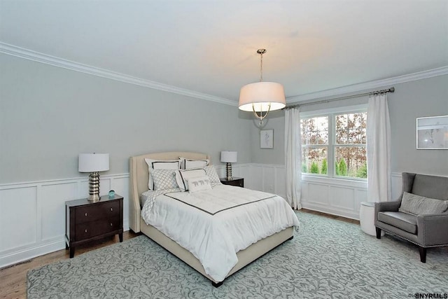 bedroom featuring crown molding and wood-type flooring