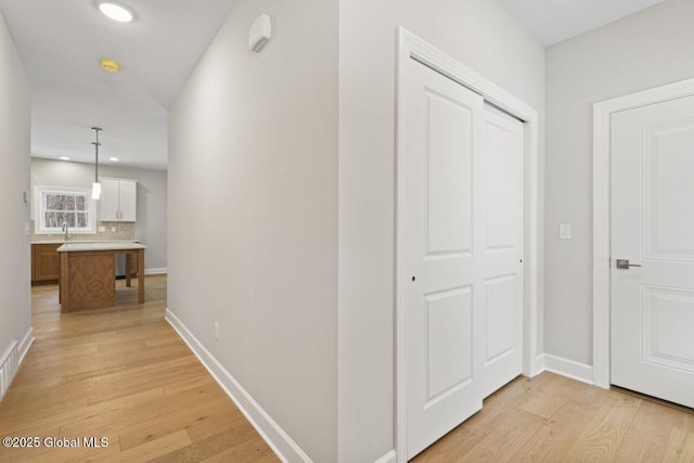 hall with light wood-type flooring