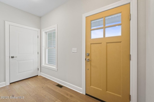 foyer with light hardwood / wood-style floors and a healthy amount of sunlight