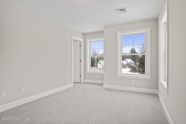 unfurnished room featuring light carpet