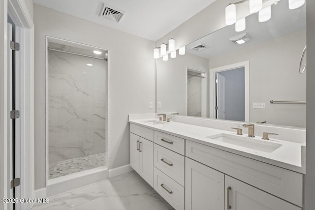 bathroom with vanity and a tile shower