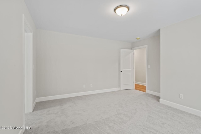 unfurnished room featuring light carpet