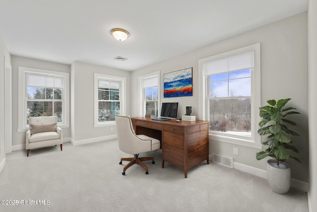 carpeted office space with plenty of natural light