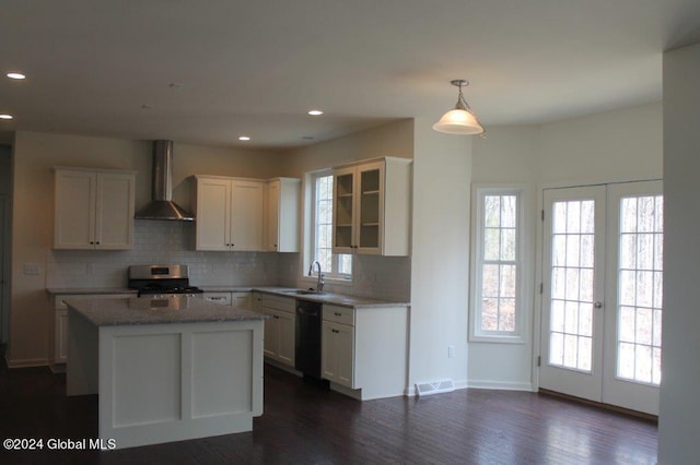 kitchen featuring french doors, dark hardwood / wood-style flooring, wall chimney exhaust hood, sink, and black dishwasher