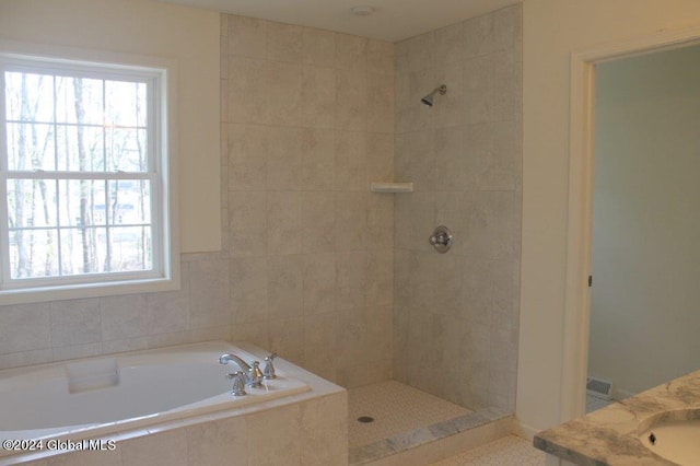 bathroom with plus walk in shower and vanity