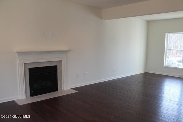 unfurnished living room featuring dark hardwood / wood-style flooring