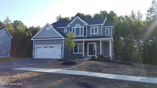 craftsman-style house featuring a porch and a garage