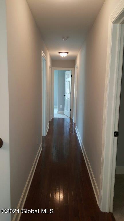 hallway featuring dark hardwood / wood-style flooring