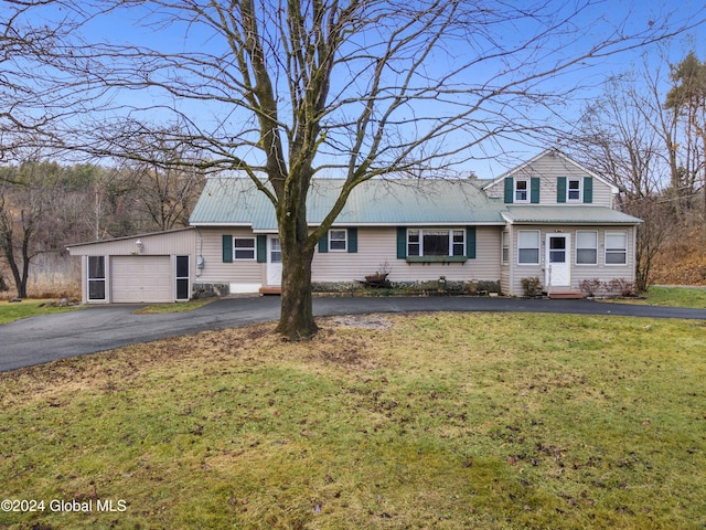 view of front of property with a garage and a front yard