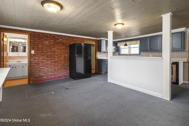 unfurnished living room with dark carpet, crown molding, and brick wall