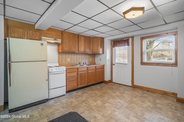 kitchen featuring a drop ceiling, extractor fan, white appliances, and sink