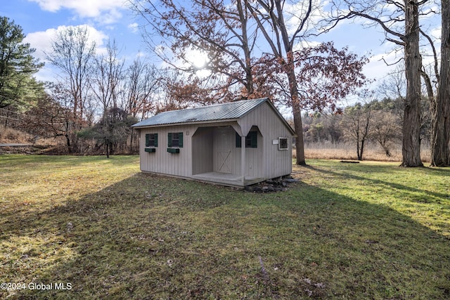 view of outbuilding with a yard