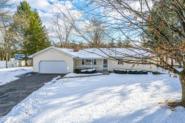 ranch-style house with covered porch and a garage