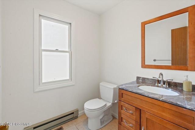 bathroom with tile patterned flooring, vanity, toilet, and a baseboard heating unit