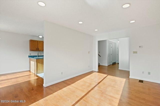 spare room with light hardwood / wood-style flooring and sink