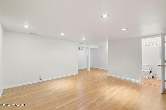 basement with light hardwood / wood-style flooring