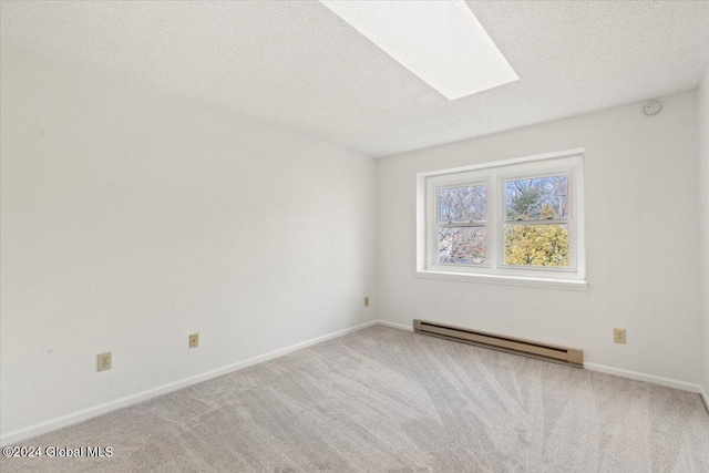 unfurnished room with a textured ceiling, baseboard heating, and carpet