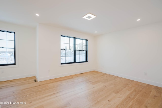 spare room featuring light hardwood / wood-style flooring