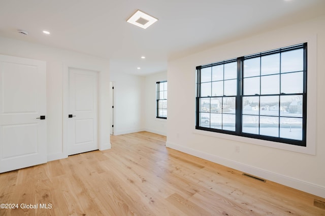 unfurnished room with light hardwood / wood-style floors