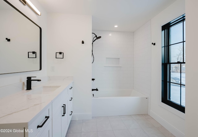 bathroom with vanity and tiled shower / bath