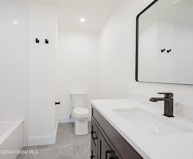 bathroom with tile patterned floors, vanity, and toilet