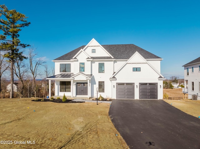 modern farmhouse style home with a garage and a front lawn