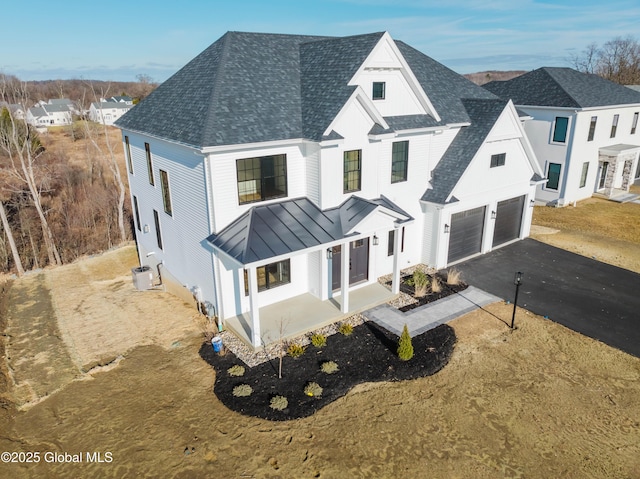 view of front of home featuring covered porch and a garage