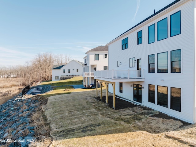 rear view of house with a yard and a deck