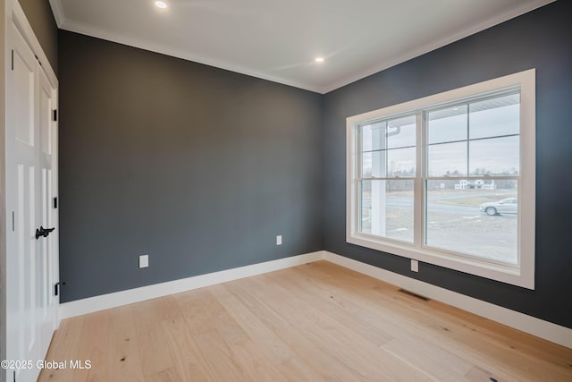 empty room with light wood-type flooring, baseboards, visible vents, recessed lighting, and crown molding