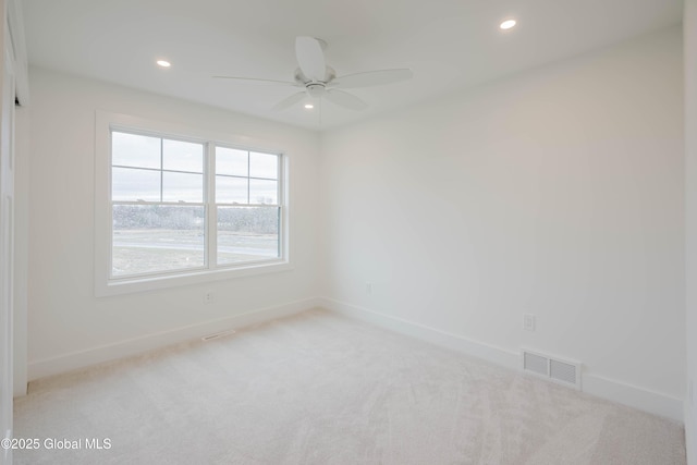 carpeted spare room with visible vents, baseboards, recessed lighting, and ceiling fan