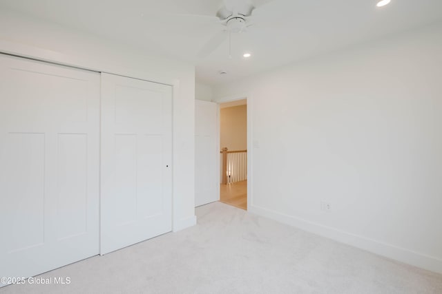 unfurnished bedroom with baseboards, carpet flooring, recessed lighting, and a closet