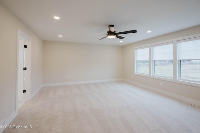 unfurnished room with a ceiling fan, light carpet, baseboards, visible vents, and recessed lighting
