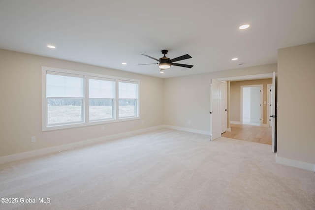 spare room with ceiling fan, light carpet, baseboards, and recessed lighting