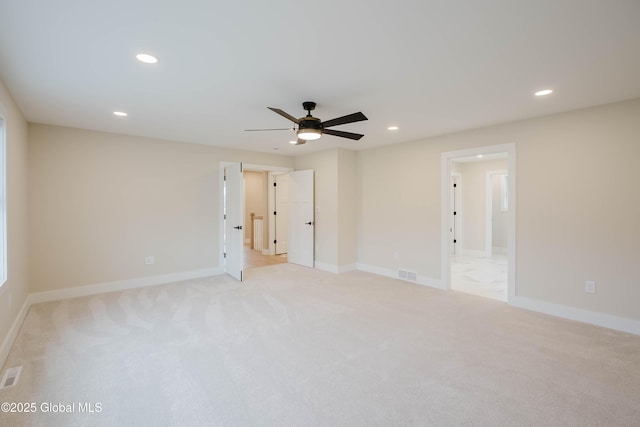 empty room with light colored carpet, ceiling fan, visible vents, and recessed lighting