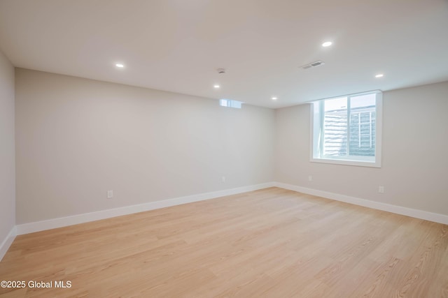 unfurnished room with recessed lighting, visible vents, light wood finished floors, and baseboards