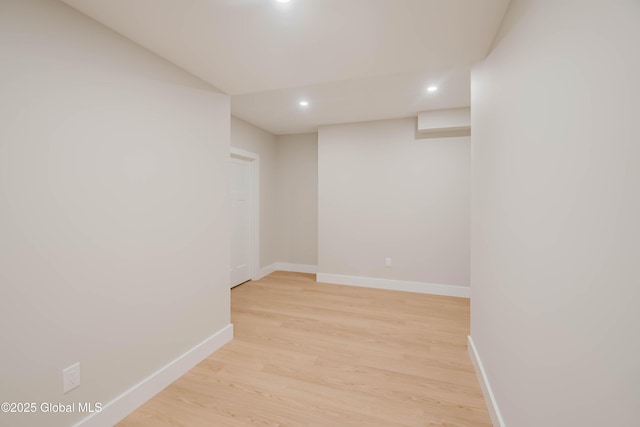unfurnished room with recessed lighting, light wood finished floors, and baseboards