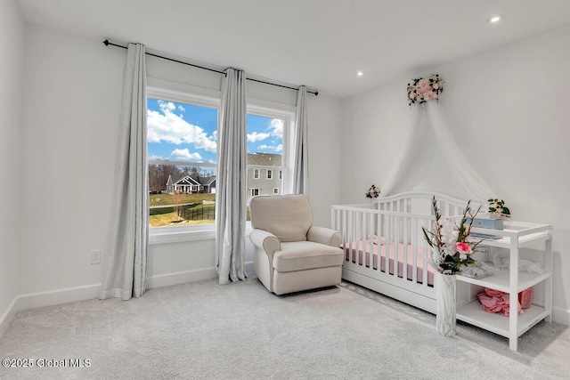 carpeted bedroom with a crib and multiple windows