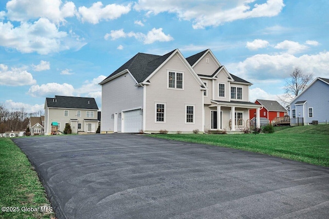 view of property featuring a front lawn and a garage