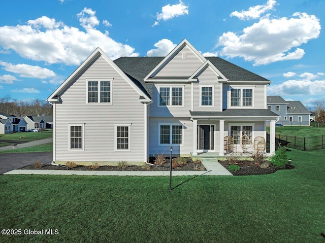 view of front property with covered porch and a front lawn