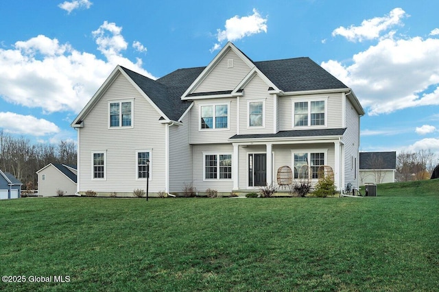 view of front property with a front yard and central air condition unit