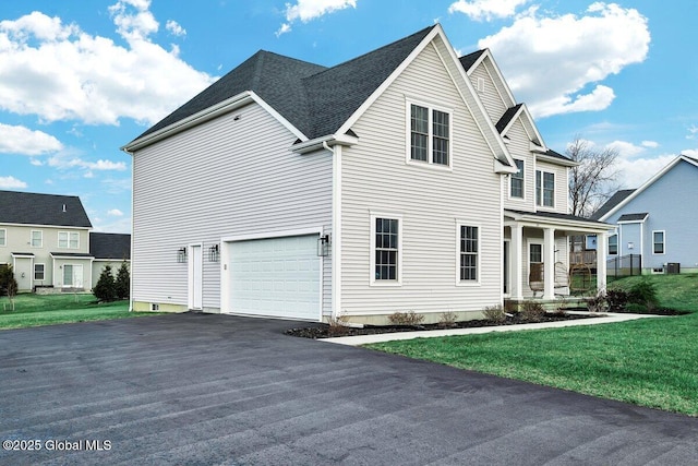 view of side of property with a lawn and a garage