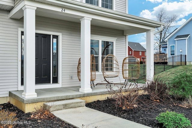 view of exterior entry featuring covered porch