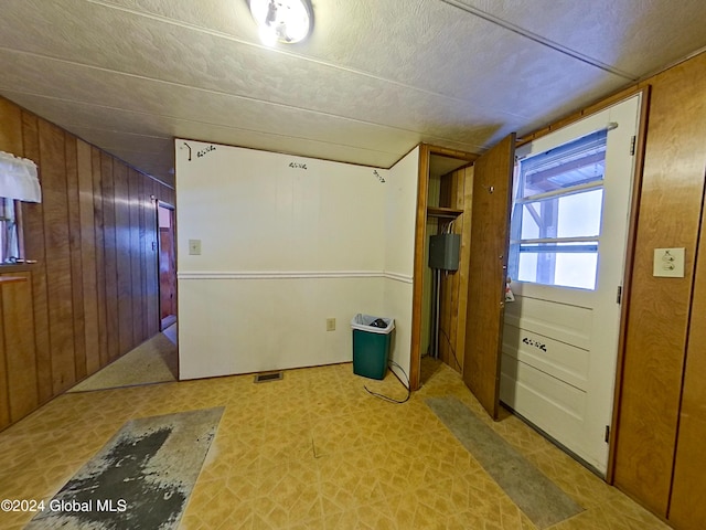 basement featuring wood walls